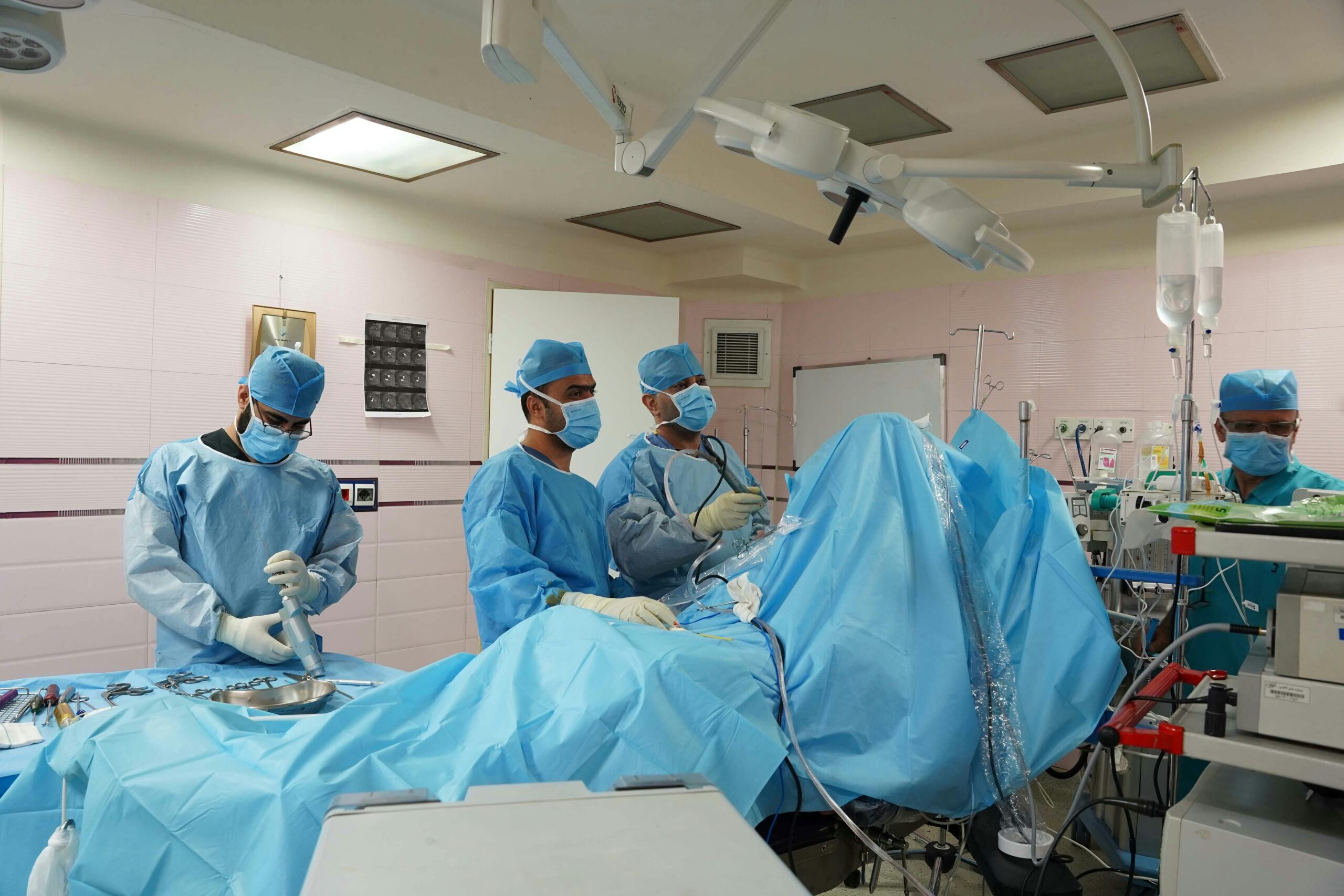 Doctors performing surgery in a hospital's operating room, utilizing medical equipment and surgical instruments.