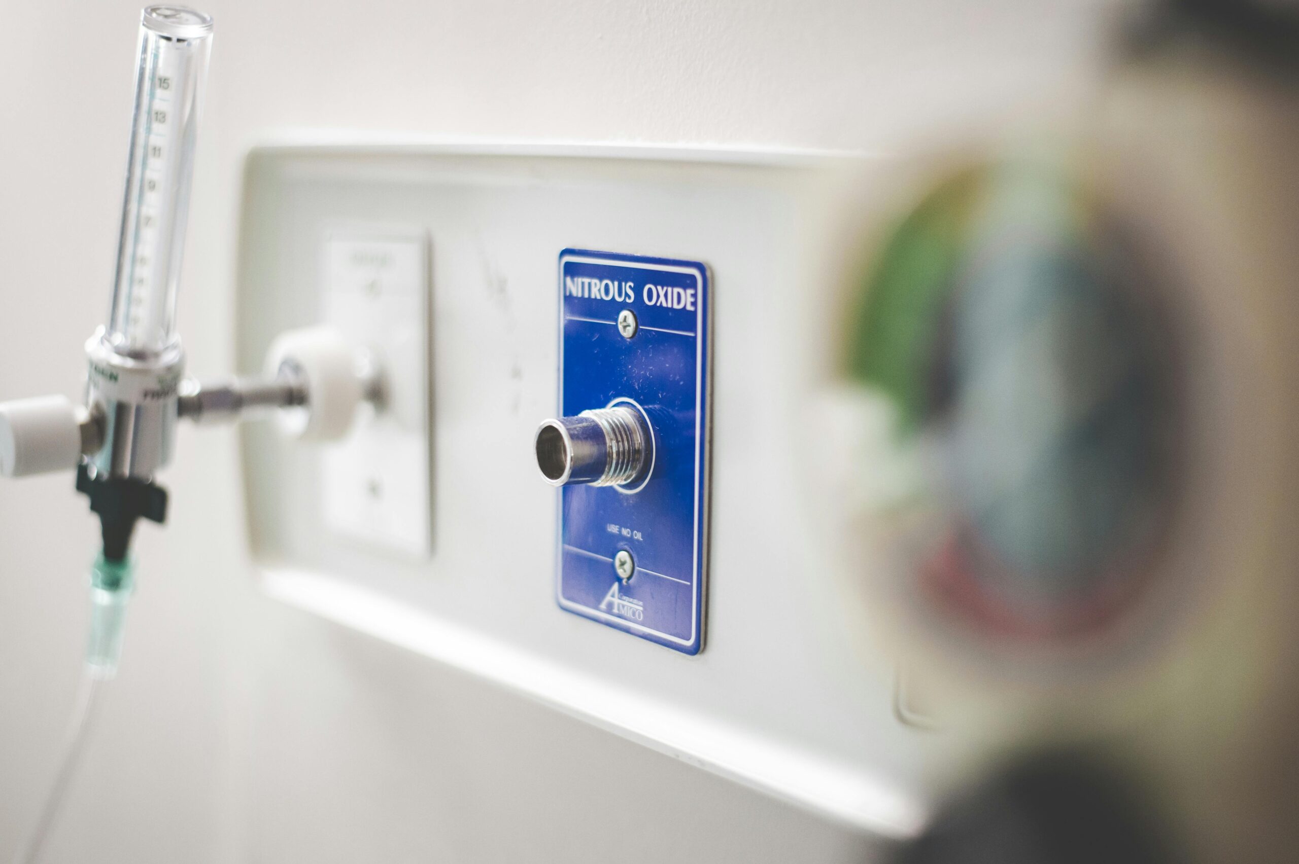 Close-up of nitrous oxide outlet and equipment in a hospital setting.